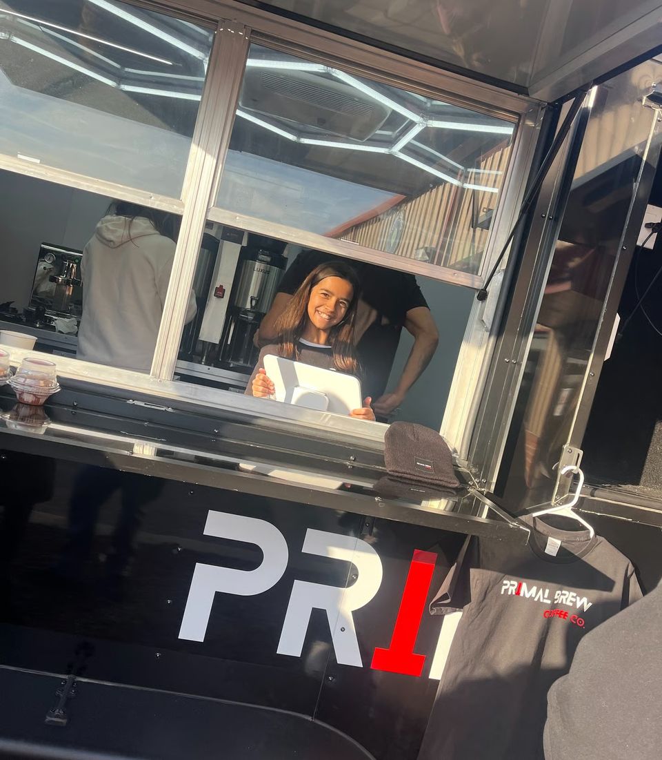 Primal Brew barista at the coffee trailer window